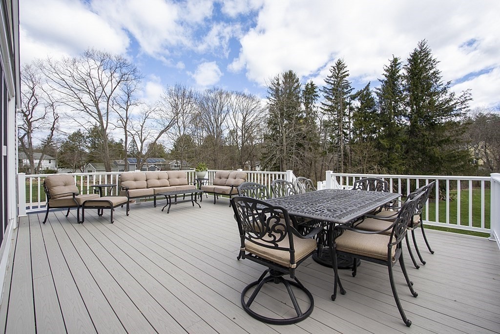 97 Argilla Road Andover, MA 01810 - Photo 33 of 42 a view of a roof deck with table and chairs with wooden floor and fence