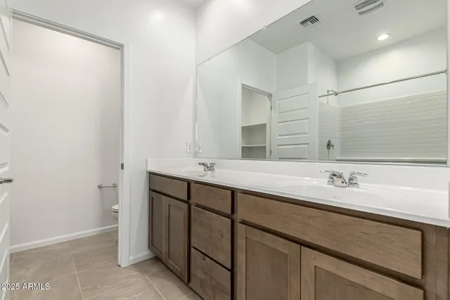 a bathroom with a double vanity sink and a mirror
