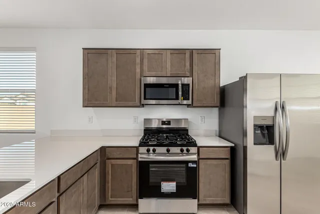 a kitchen with a refrigerator stove and microwave