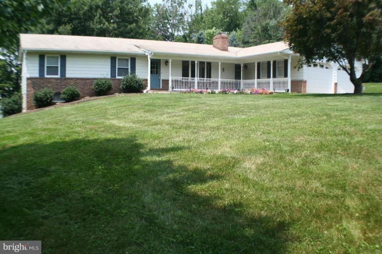 304 Warfieldsburg Road Westminster, MD 21157 - Photo 1 of 19 a front view of a house with a garden