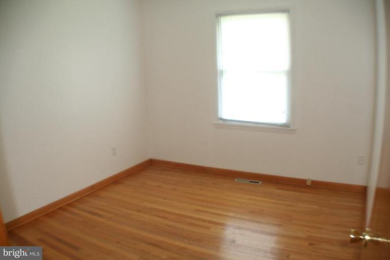 304 Warfieldsburg Road Westminster, MD 21157 - Photo 12 of 19 an empty room with wooden floor and windows