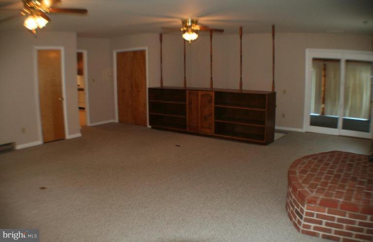 304 Warfieldsburg Road Westminster, MD 21157 - Photo 4 of 19 an empty room with furniture and wooden floor