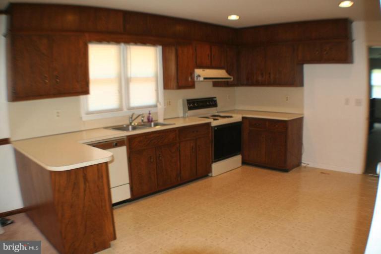 304 Warfieldsburg Road Westminster, MD 21157 - Photo 8 of 19 a kitchen with a sink a stove a refrigerator and a sink