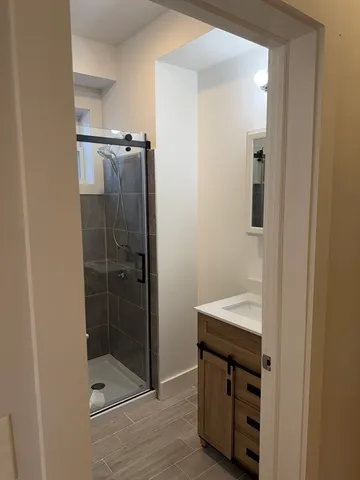 a bathroom with a shower and a sink
