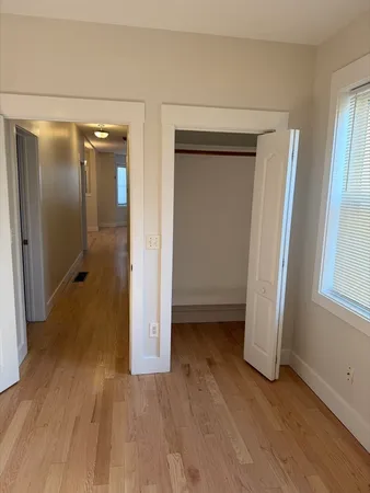 a view of a room with wooden floor and a sink