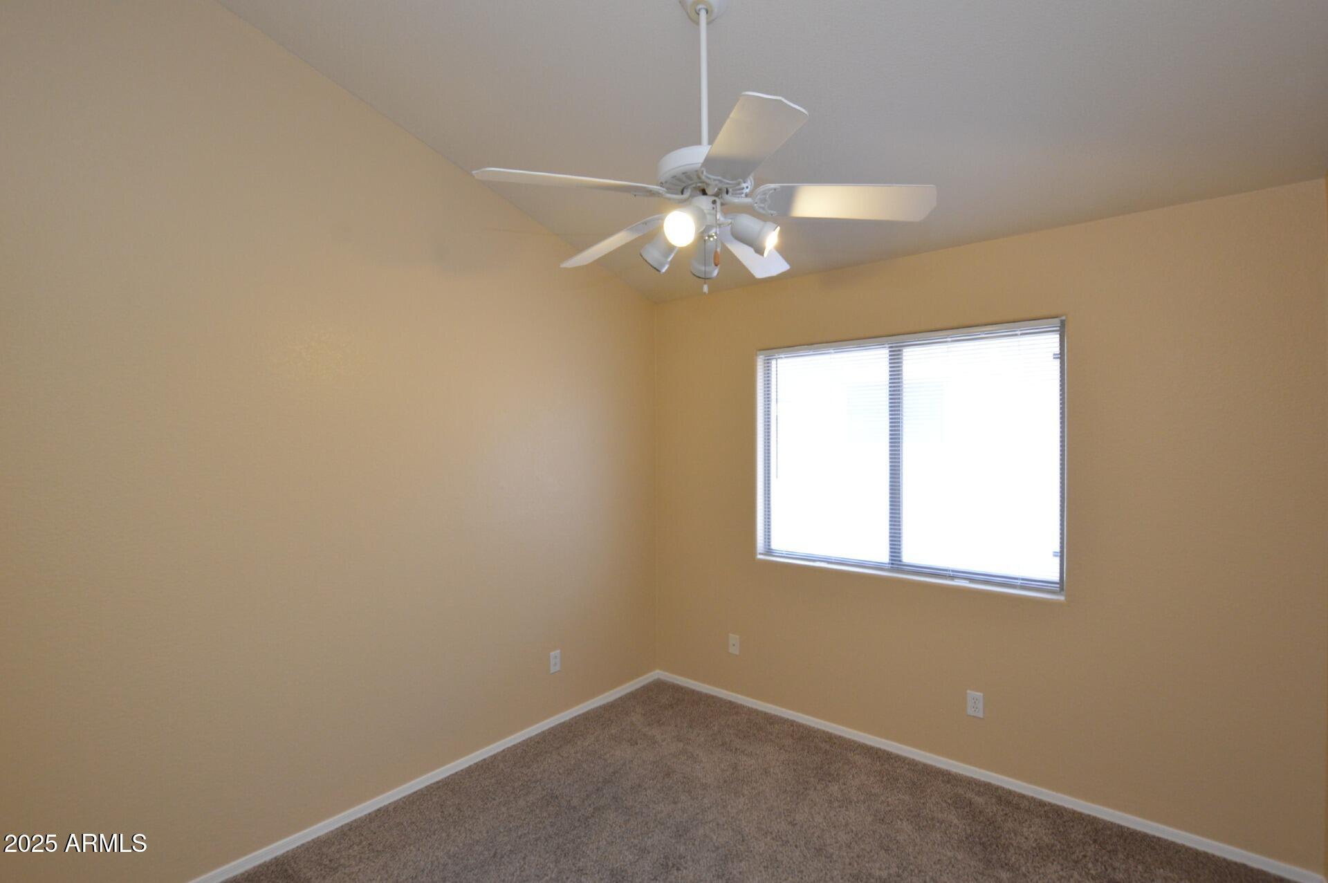 4094 East Rustler Way Gilbert, AZ 85297 - Photo 12 of 34 an empty room with a window and a fan