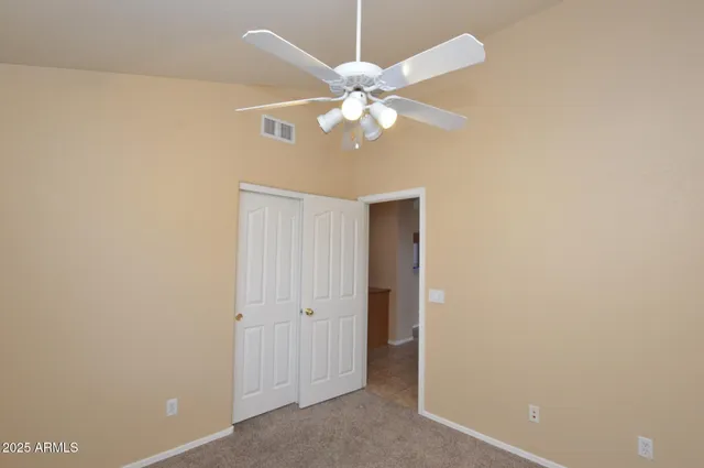 a view of a chandelier fan and closet in a room