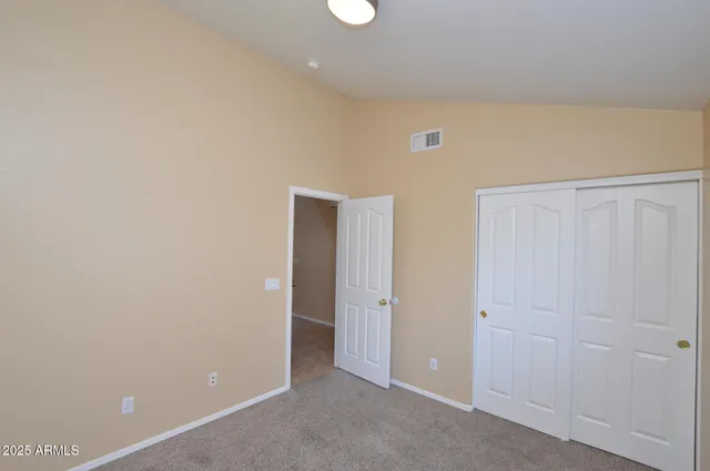 an empty room with closet area