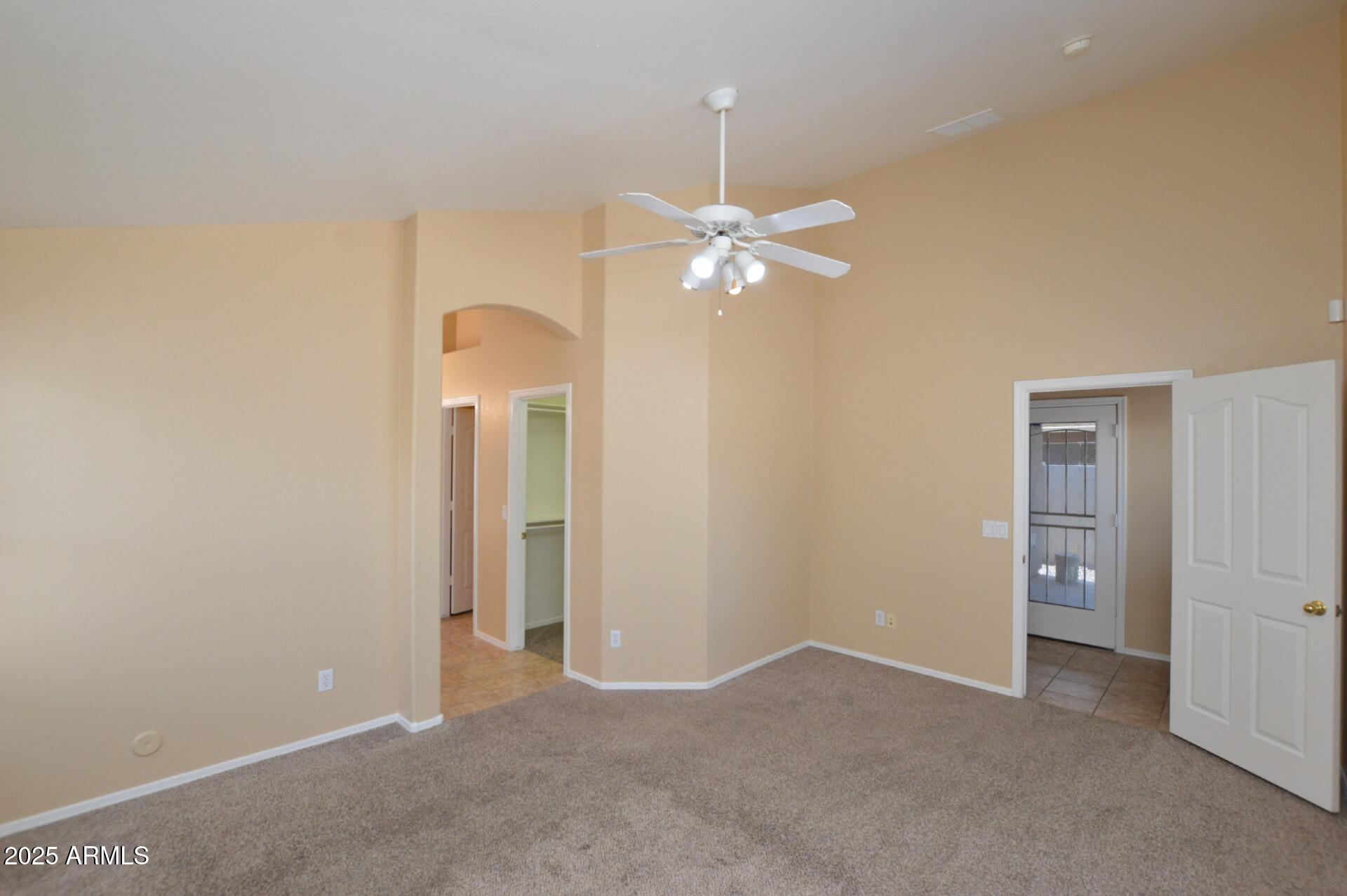 4094 East Rustler Way Gilbert, AZ 85297 - Photo 17 of 34 an empty room with a chandelier fan and a window