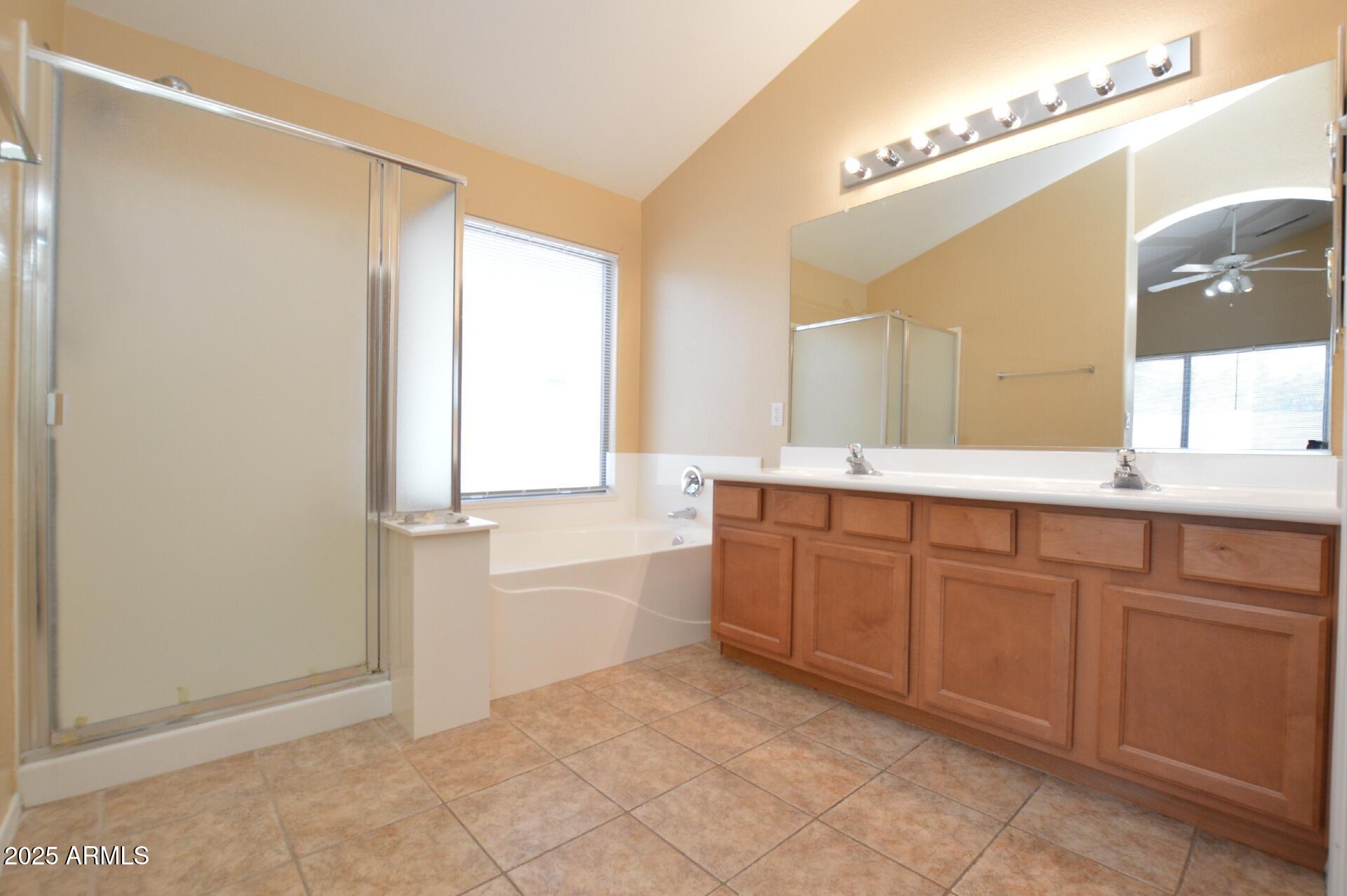 4094 East Rustler Way Gilbert, AZ 85297 - Photo 18 of 34 a spacious bathroom with a granite countertop sink mirror and a bathtub