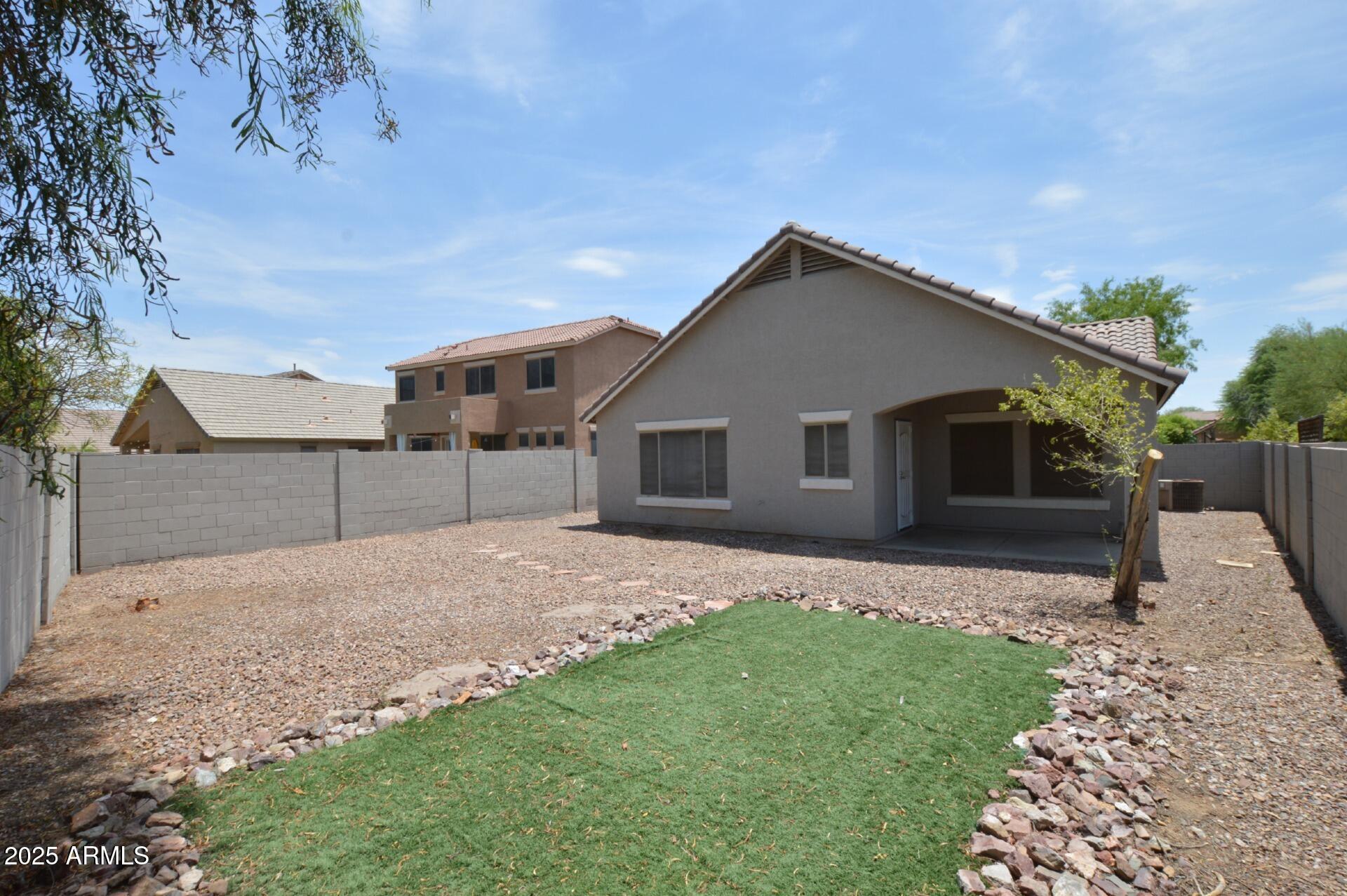 4094 East Rustler Way Gilbert, AZ 85297 - Photo 23 of 34 a front view of a house with a yard and garage