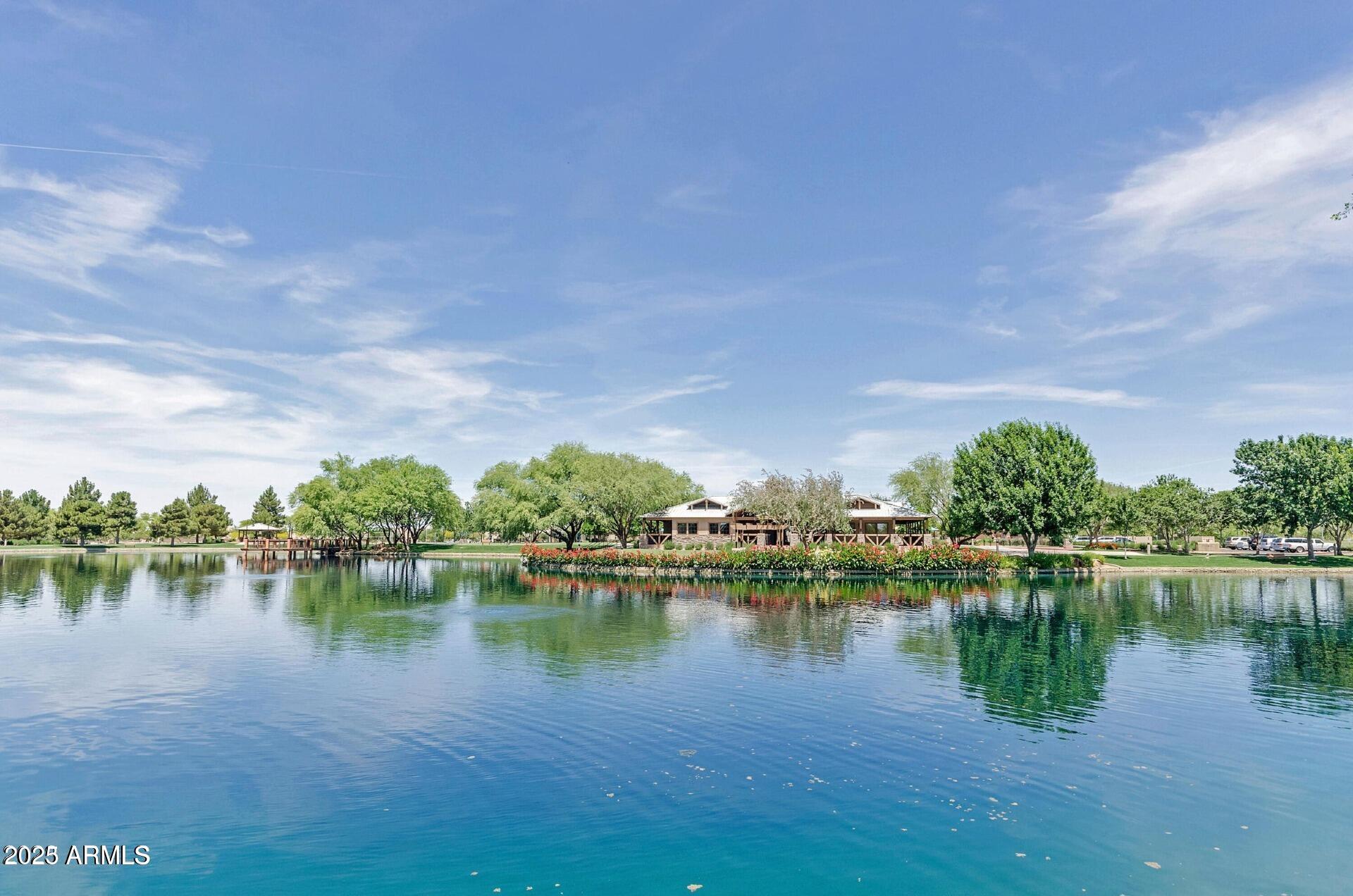 4094 East Rustler Way Gilbert, AZ 85297 - Photo 27 of 34 a view of a lake with houses in the back
