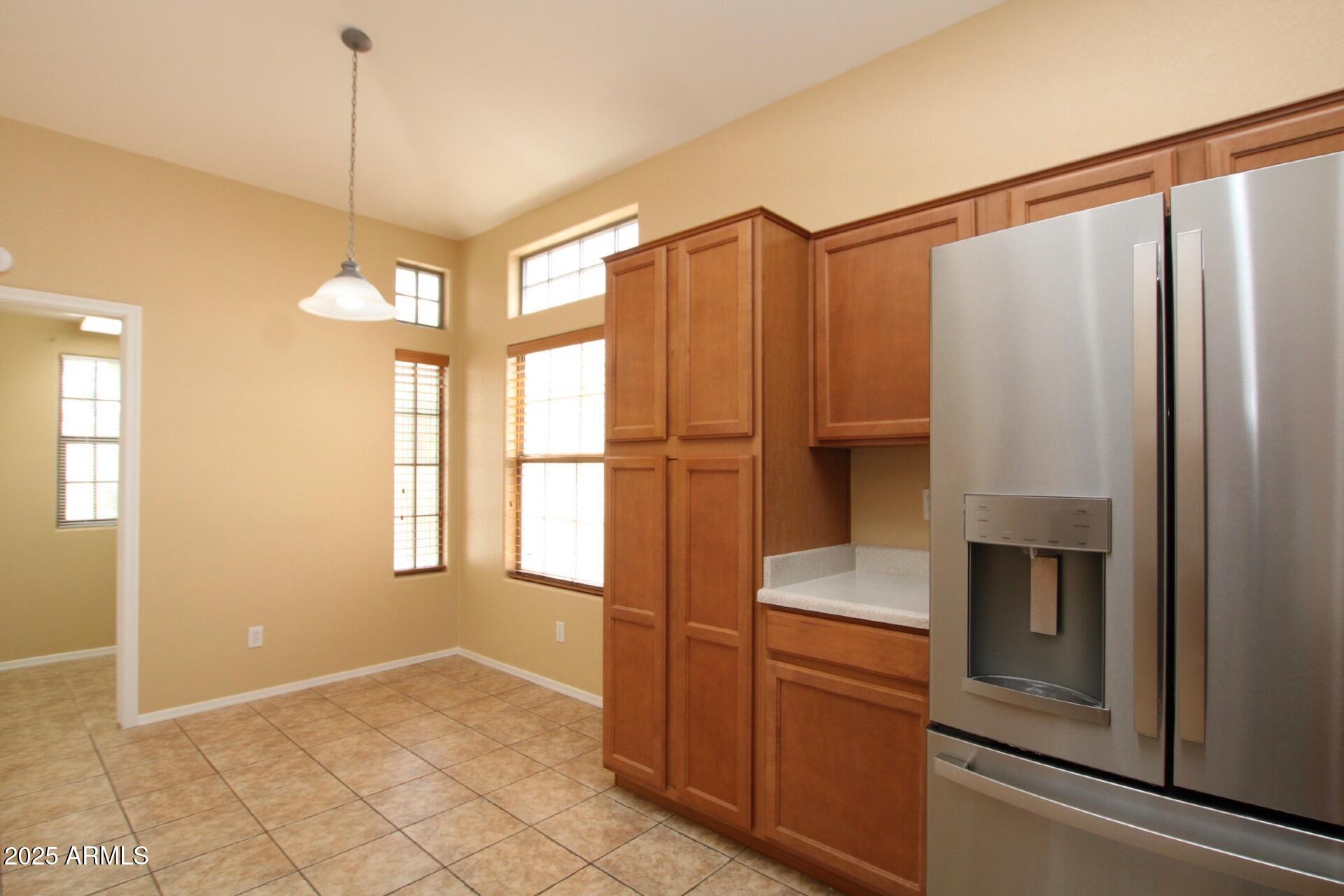 4094 East Rustler Way Gilbert, AZ 85297 - Photo 3 of 34 a kitchen with a refrigerator and window