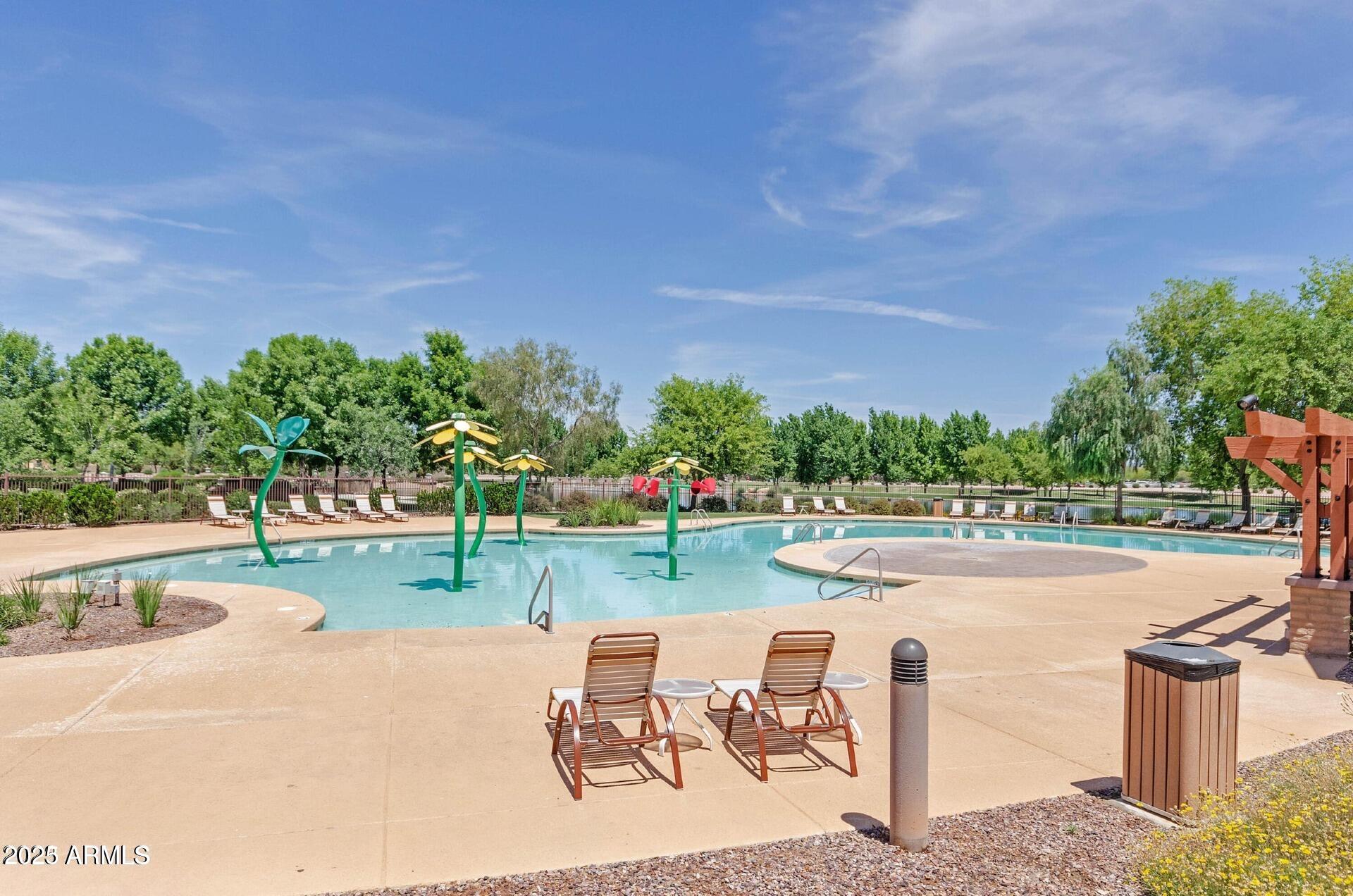 4094 East Rustler Way Gilbert, AZ 85297 - Photo 33 of 34 a view of a swimming pool and lounge chairs
