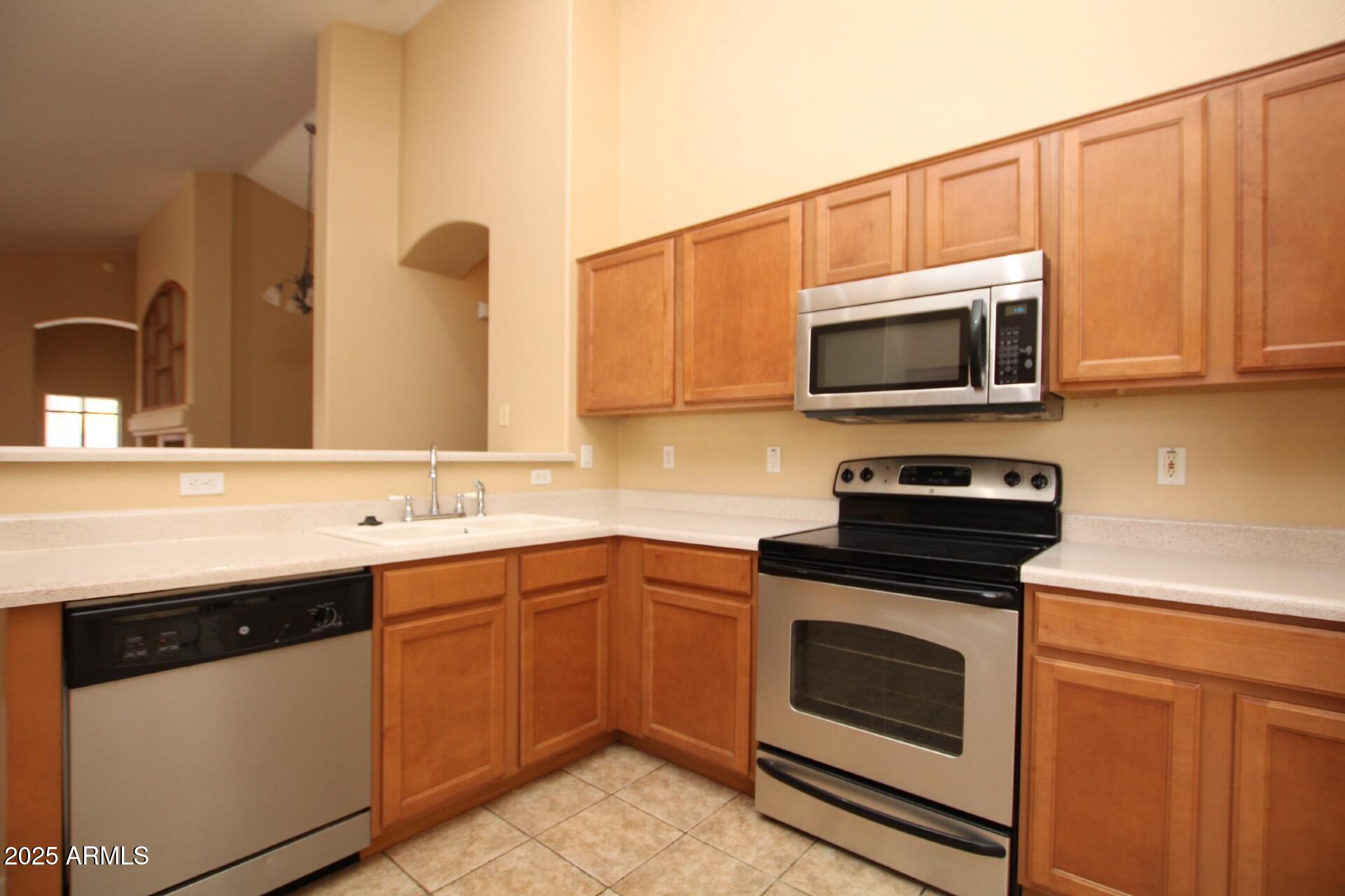4094 East Rustler Way Gilbert, AZ 85297 - Photo 4 of 34 a kitchen with a sink stove and microwave
