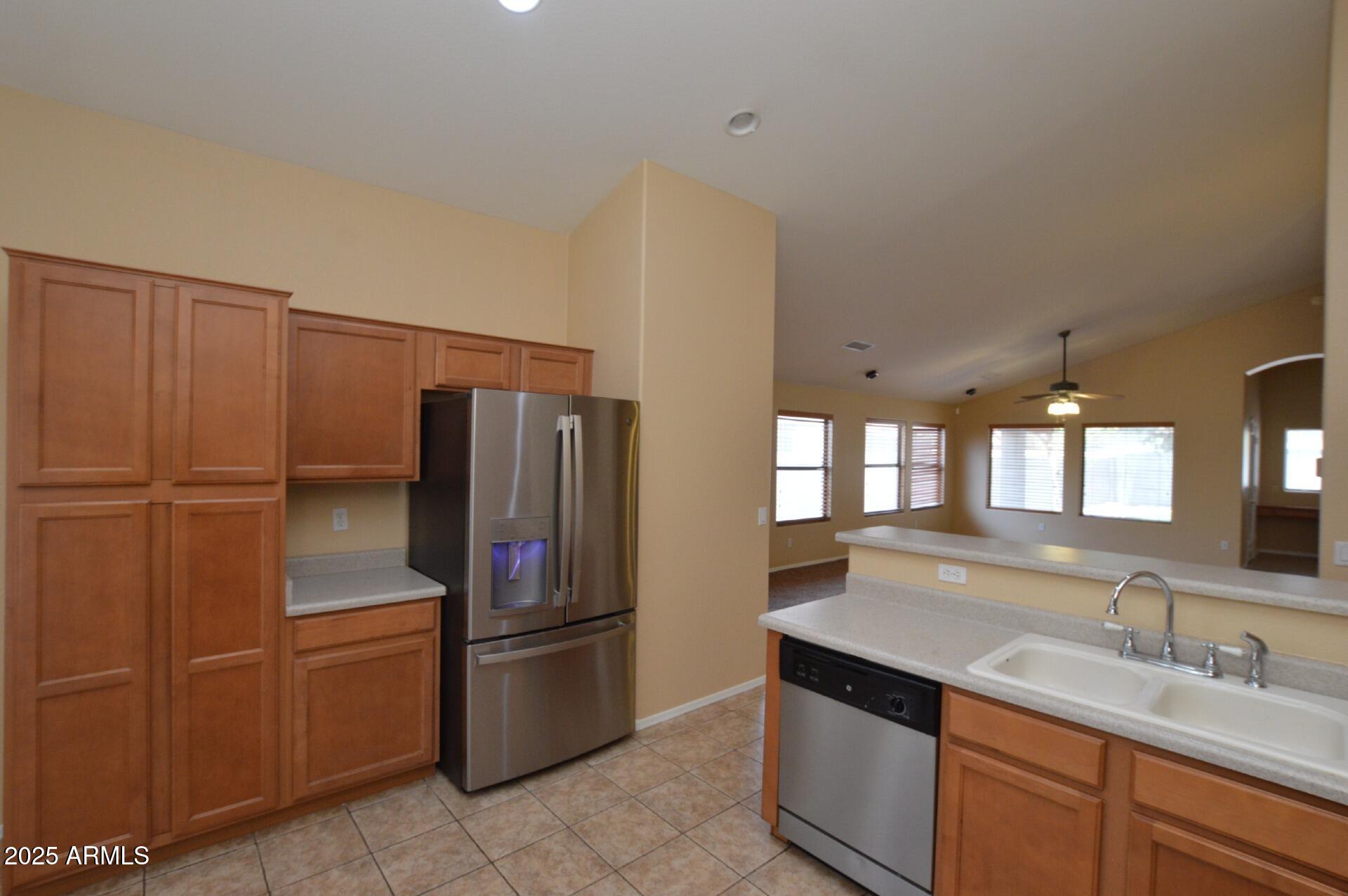 4094 East Rustler Way Gilbert, AZ 85297 - Photo 7 of 34 a kitchen with a refrigerator and a sink