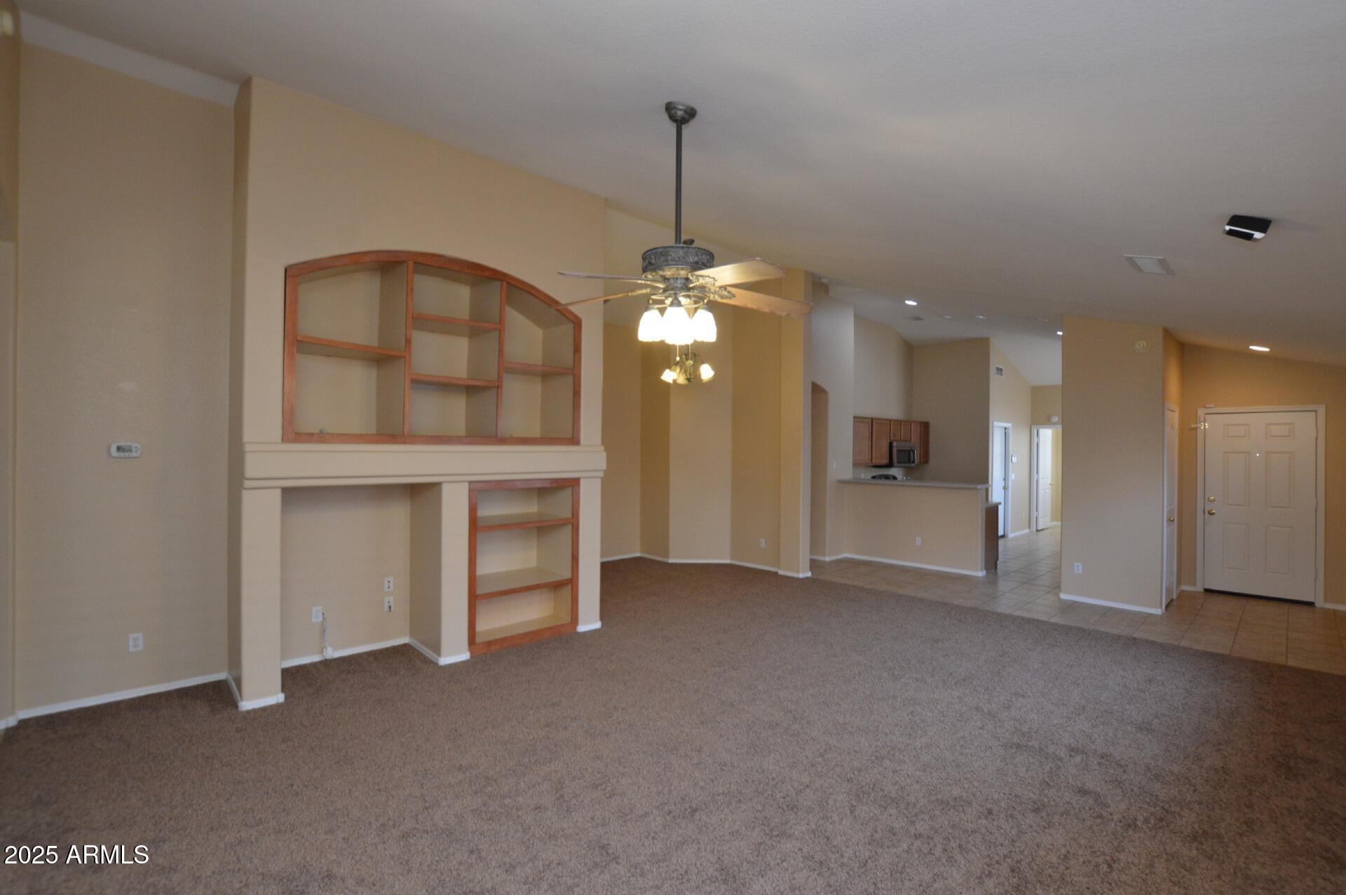 4094 East Rustler Way Gilbert, AZ 85297 - Photo 9 of 34 a view of an empty room with window and kitchen view
