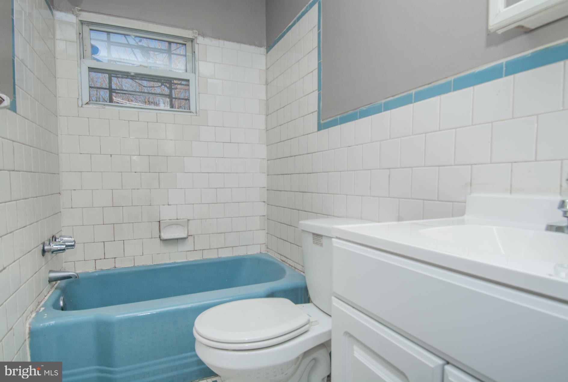 2228 Christian Street Baltimore, MD 21223 - Photo 11 of 16 a bathroom with a toilet a sink and bathtub
