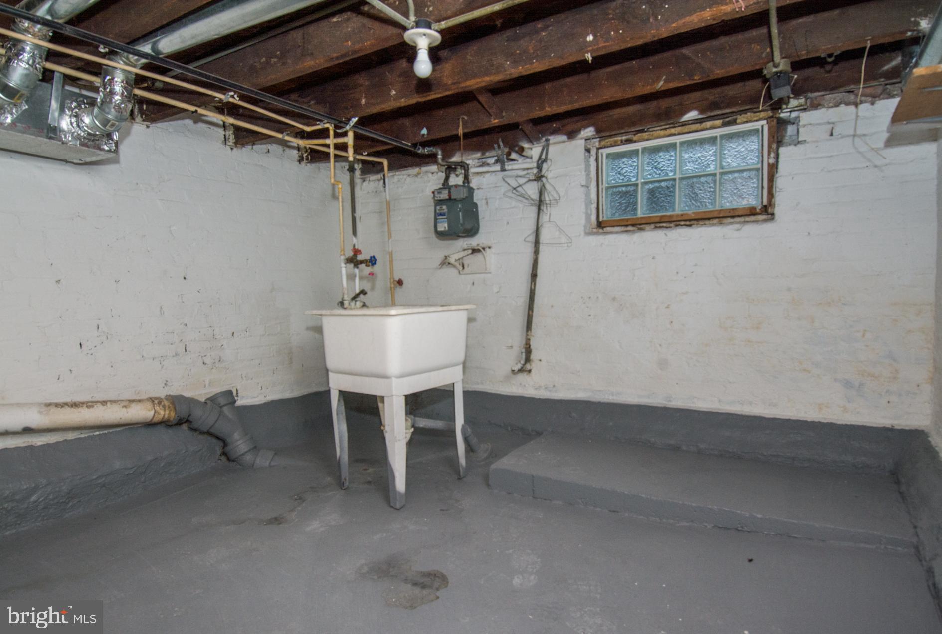 2228 Christian Street Baltimore, MD 21223 - Photo 14 of 16 a utility room with a wooden table and chairs