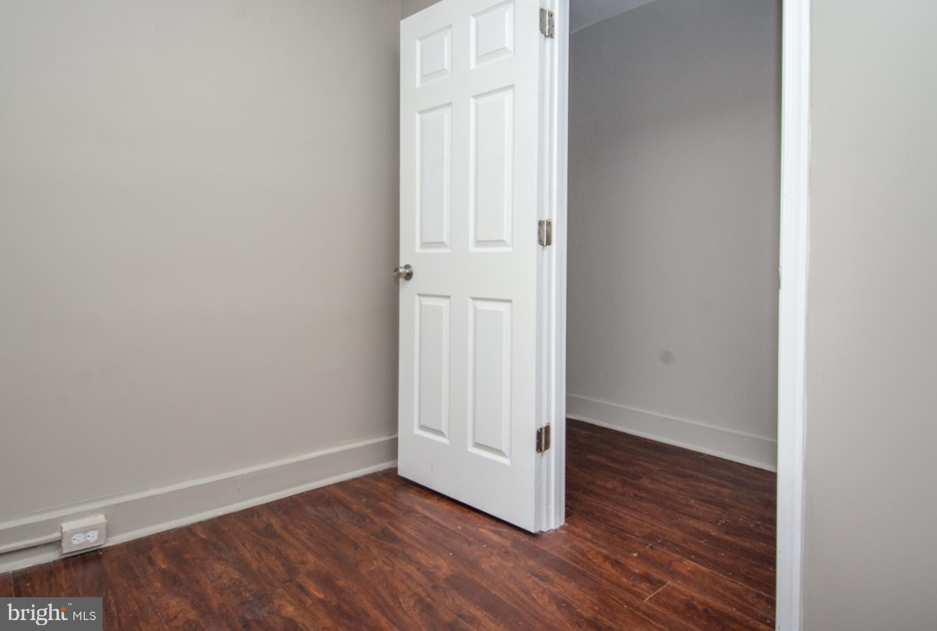 2228 Christian Street Baltimore, MD 21223 - Photo 10 of 16 a view of an empty room with wooden floor