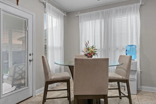 a dining room with furniture and window