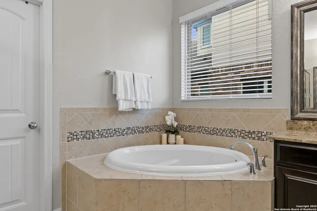 a white bath tub sitting next to a white sink