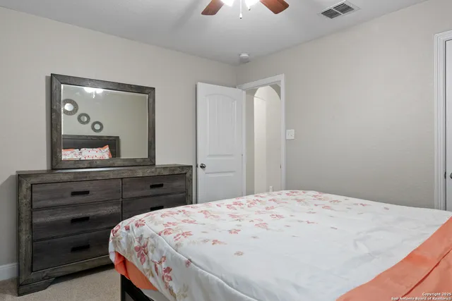 a bedroom with a bed and a dresser