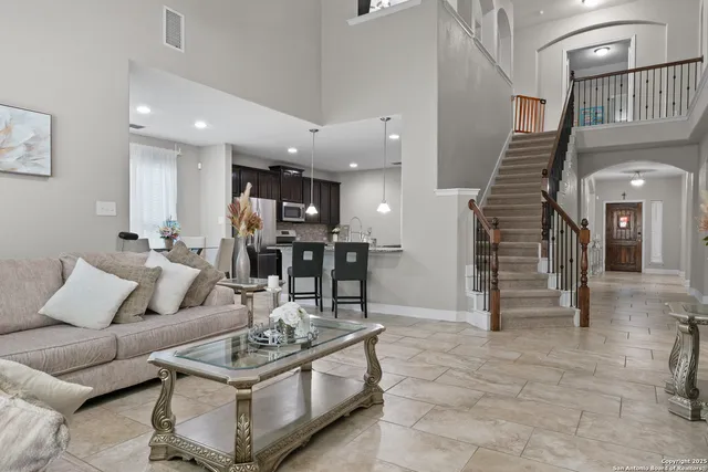 a living room with furniture and kitchen view