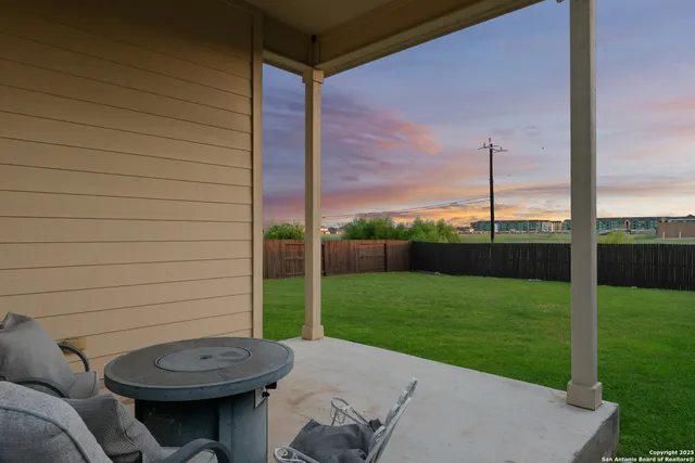 a view of a patio with a table chairs and a garden