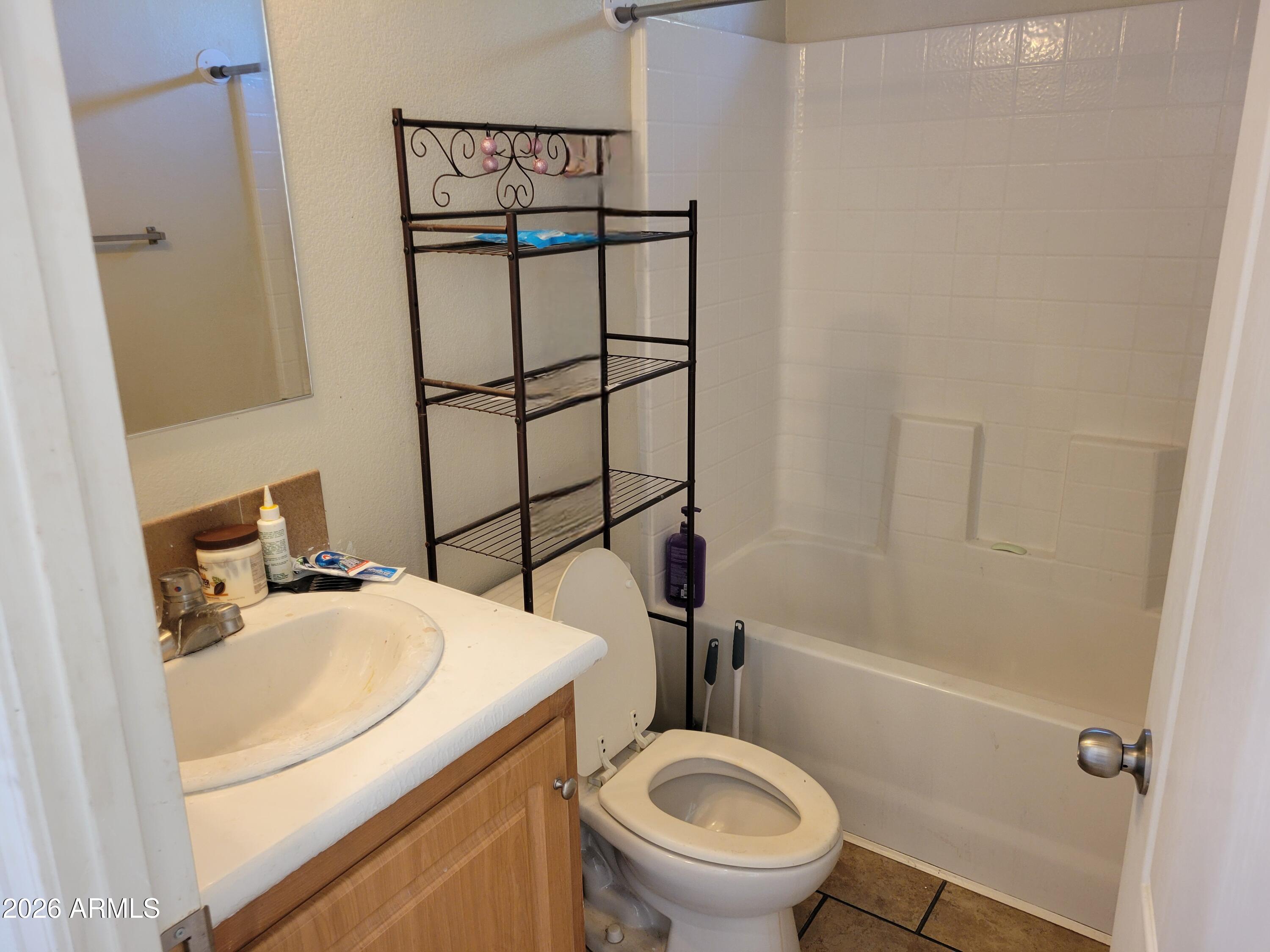 5002 West Bethany Home Road, Unit 33 Glendale, AZ 85301 - Photo 11 of 12 a bathroom with a sink toilet vanity and shower