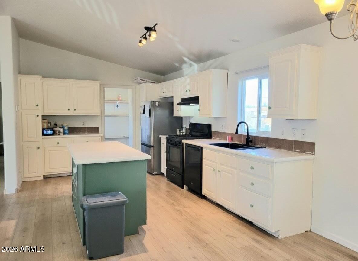 5002 West Bethany Home Road, Unit 33 Glendale, AZ 85301 - Photo 3 of 12 a kitchen with stainless steel appliances a stove refrigerator sink and cabinets