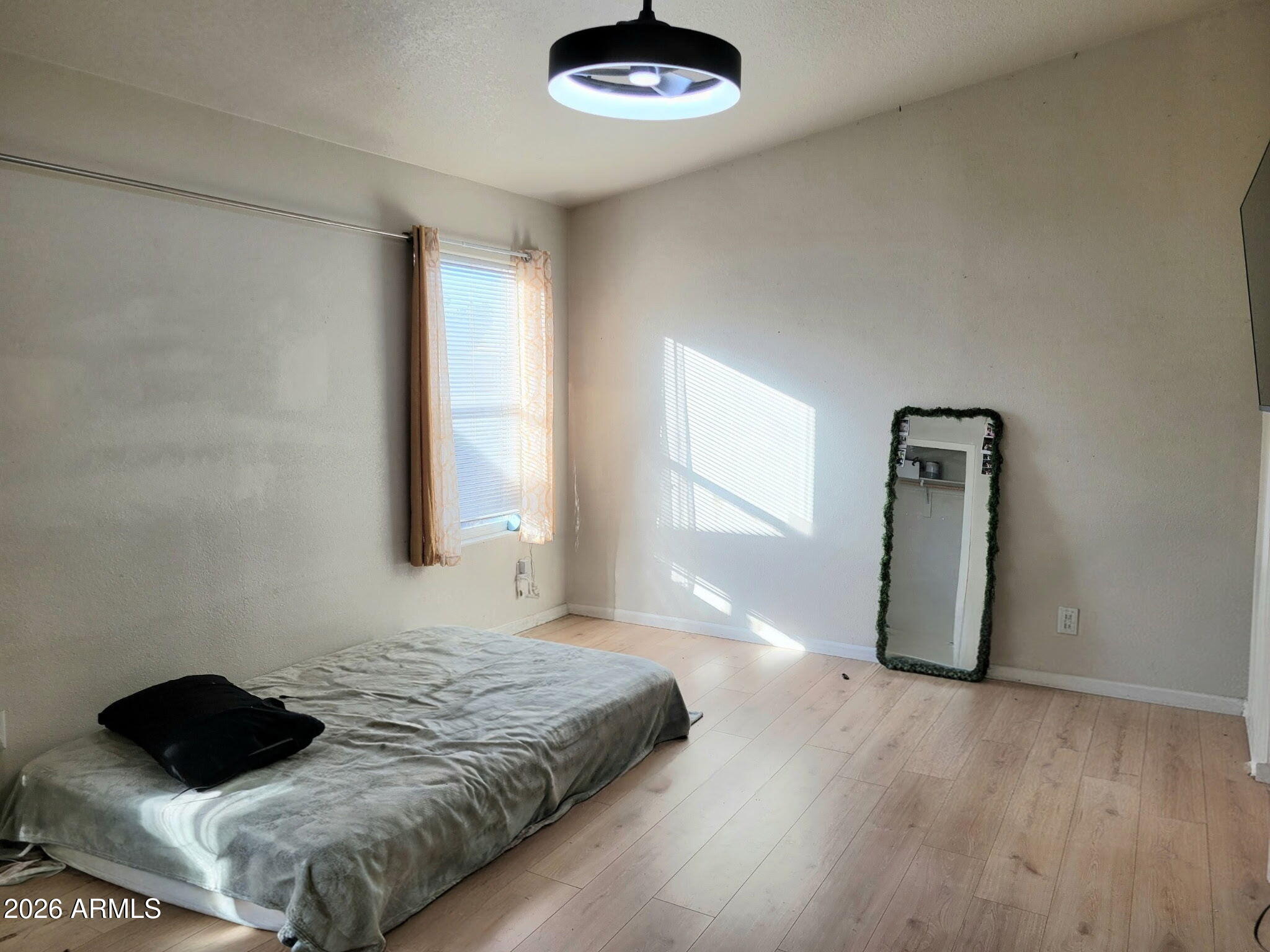 5002 West Bethany Home Road, Unit 33 Glendale, AZ 85301 - Photo 7 of 12 a bedroom with a bed and a window