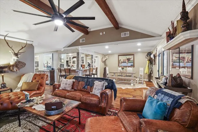 a living room with furniture a ceiling fan and a rug