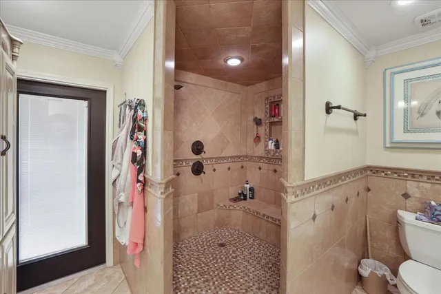a large white bathroom with a large tub sink shower and mirror