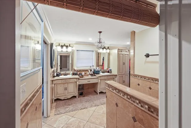 a bedroom with a bed and a tv on the dresser