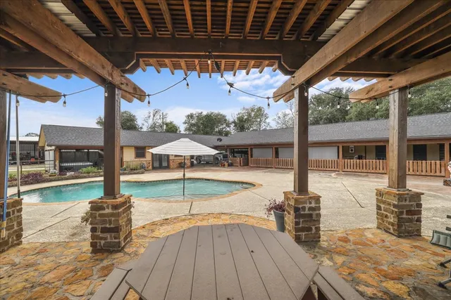 a room with furniture a flat screen tv and a large window