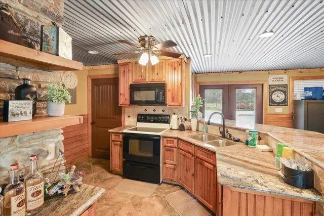 a dining room with furniture a rug and a chandelier