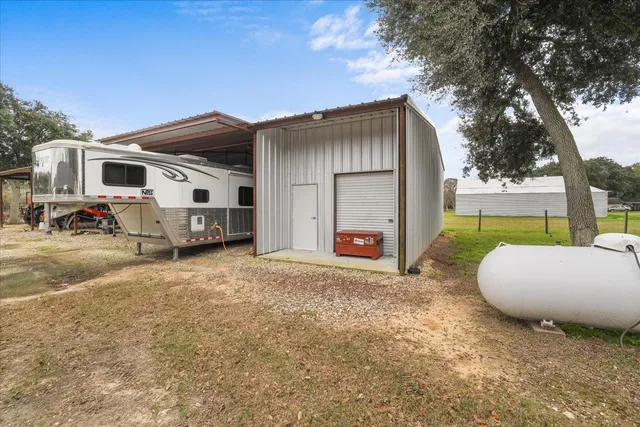 a view of a backyard with wooden fence and a bench