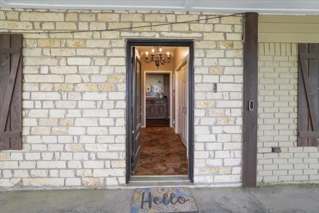 a view of a door and brick wall