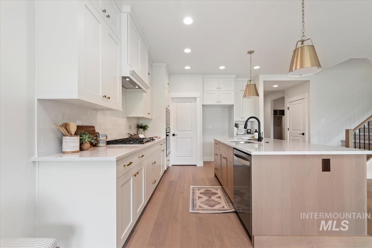 2166 East Rodeo Street Kuna, ID 83634 - Photo 11 of 43 Modern kitchen featuring white shaker cabinetry and a white subway tile backsplash