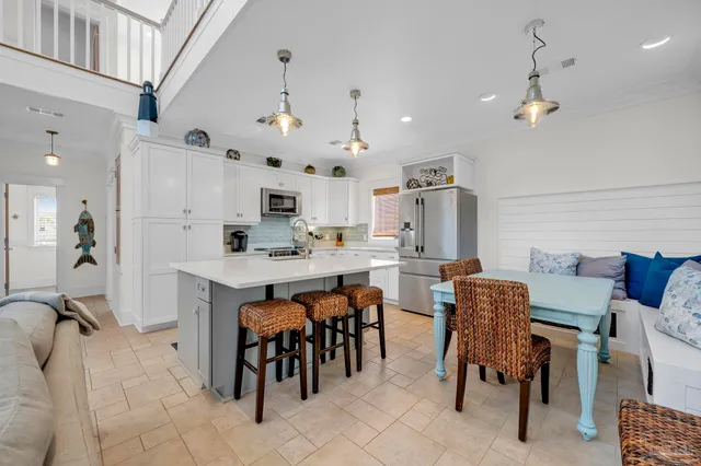 a large kitchen with a table and chairs