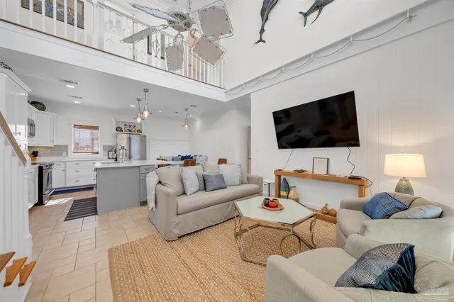 a bedroom with a bed and large windows