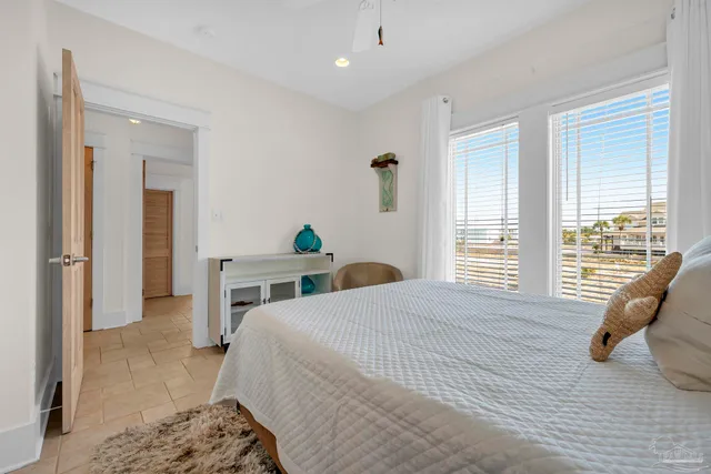 a bedroom with a bed a couch and dresser