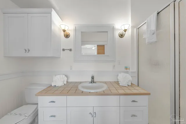 a bedroom with a bed and a chair