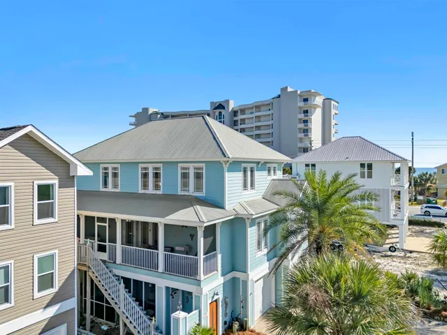 a view of a brick house with a yard and plants