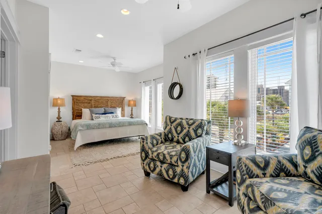 a bedroom with furniture and a large window