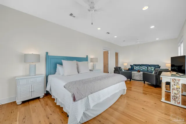 a bedroom with a bed and a view of kitchen