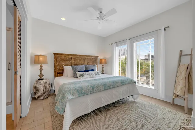 a bedroom with a large bed and a large window