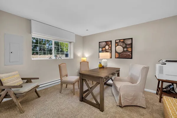 a view of a livingroom with furniture and a window