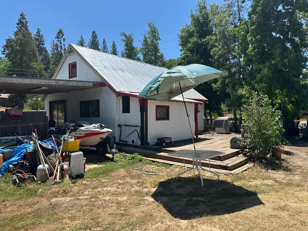 a view of a house with backyard tub and sitting area